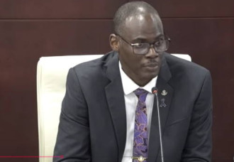 Minister Richinel Brug defends actions amid integrity allegations as parliament adjourns debate over healthcare concerns.